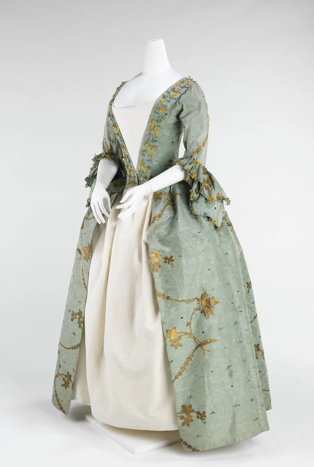 Pale green silk robe à l'anglaise, open at the front over a white petticoat; British, 1770–75; The Met 2009.300.648