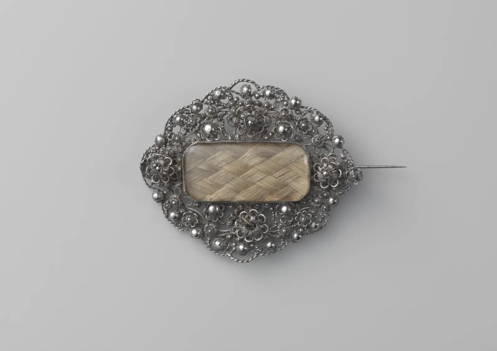 Silver filigree brooch with flat-braided light brown hair under glass; Netherlands, c. 1843; Rijksmuseum BK-NM-1120