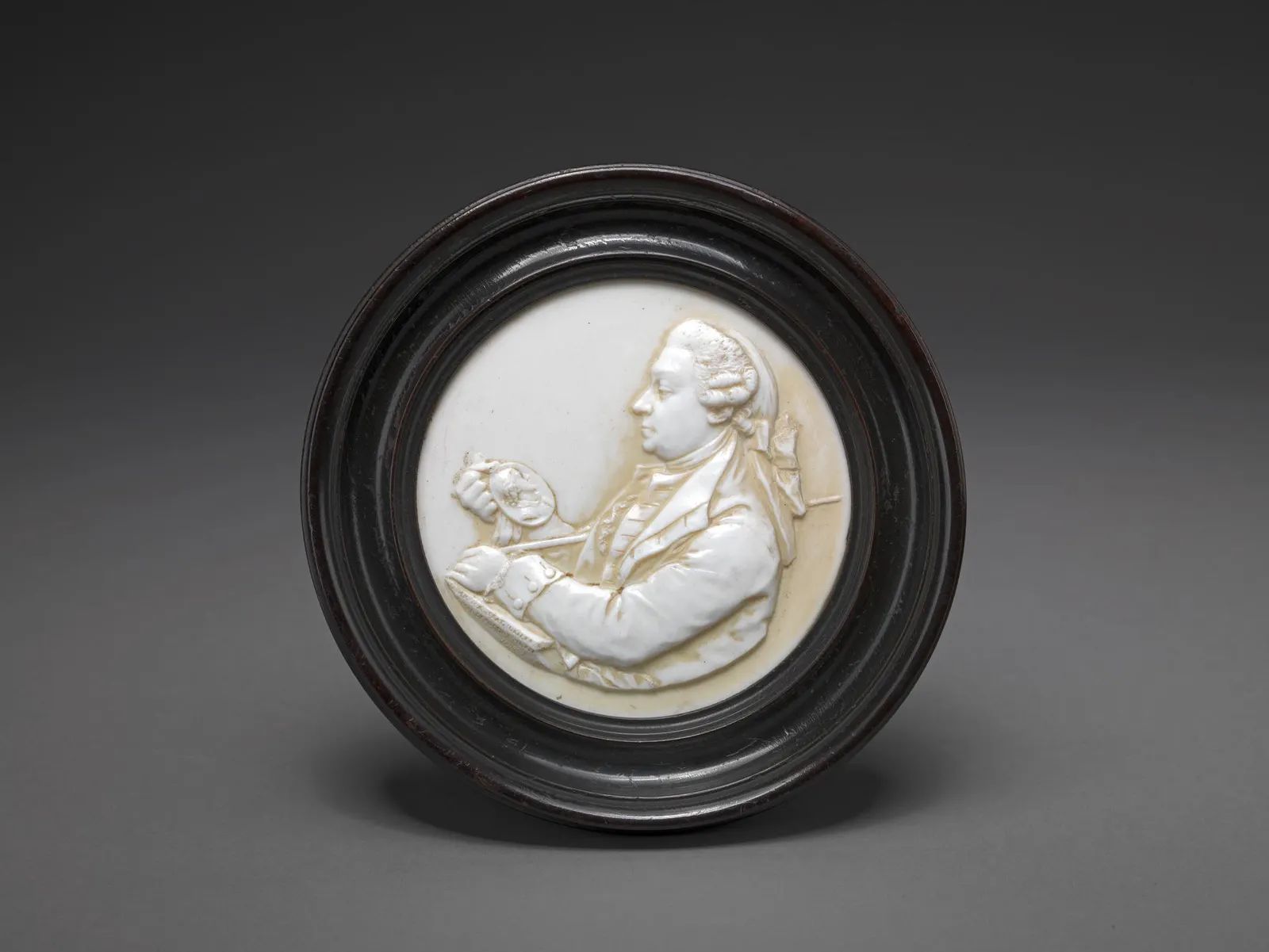 White glass-paste portrait of David Garrick in relief, round dark frame; James Tassie, 1780; Yale Center for British Art